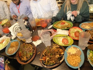 Picture of a lot of Mexican food on a wooden table at a restaurant